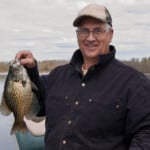 fisherman with a black crappie catch using his crappie rig